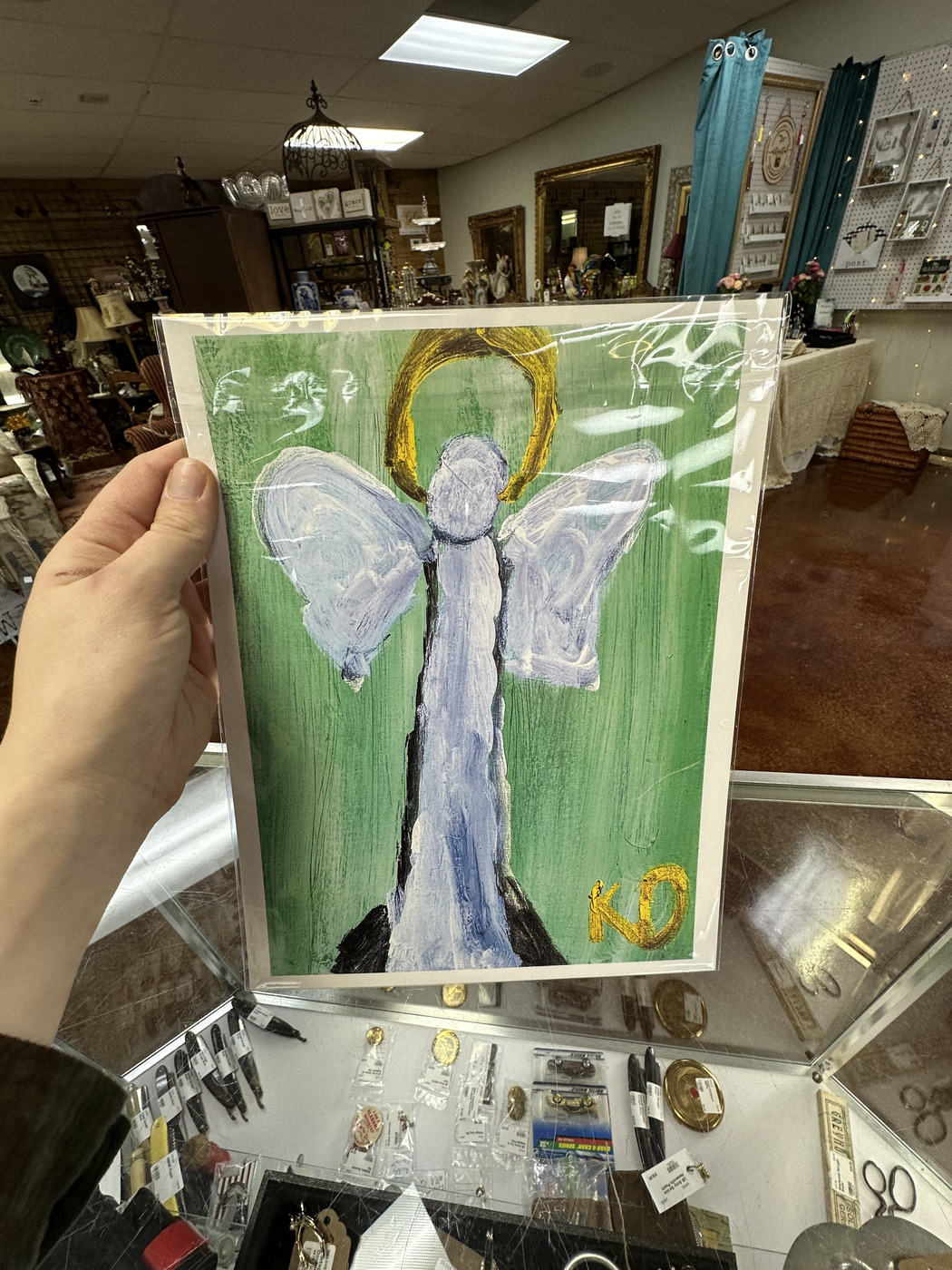 Hand-painted angel artwork featured at Triangle Trading Post