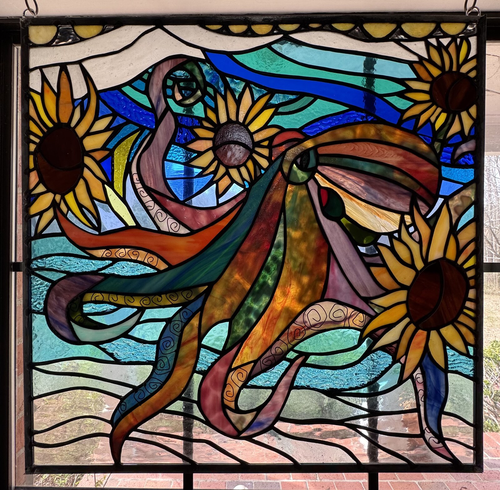 Colorful stained glass panel from June Moon classes at Triangle Trading Post