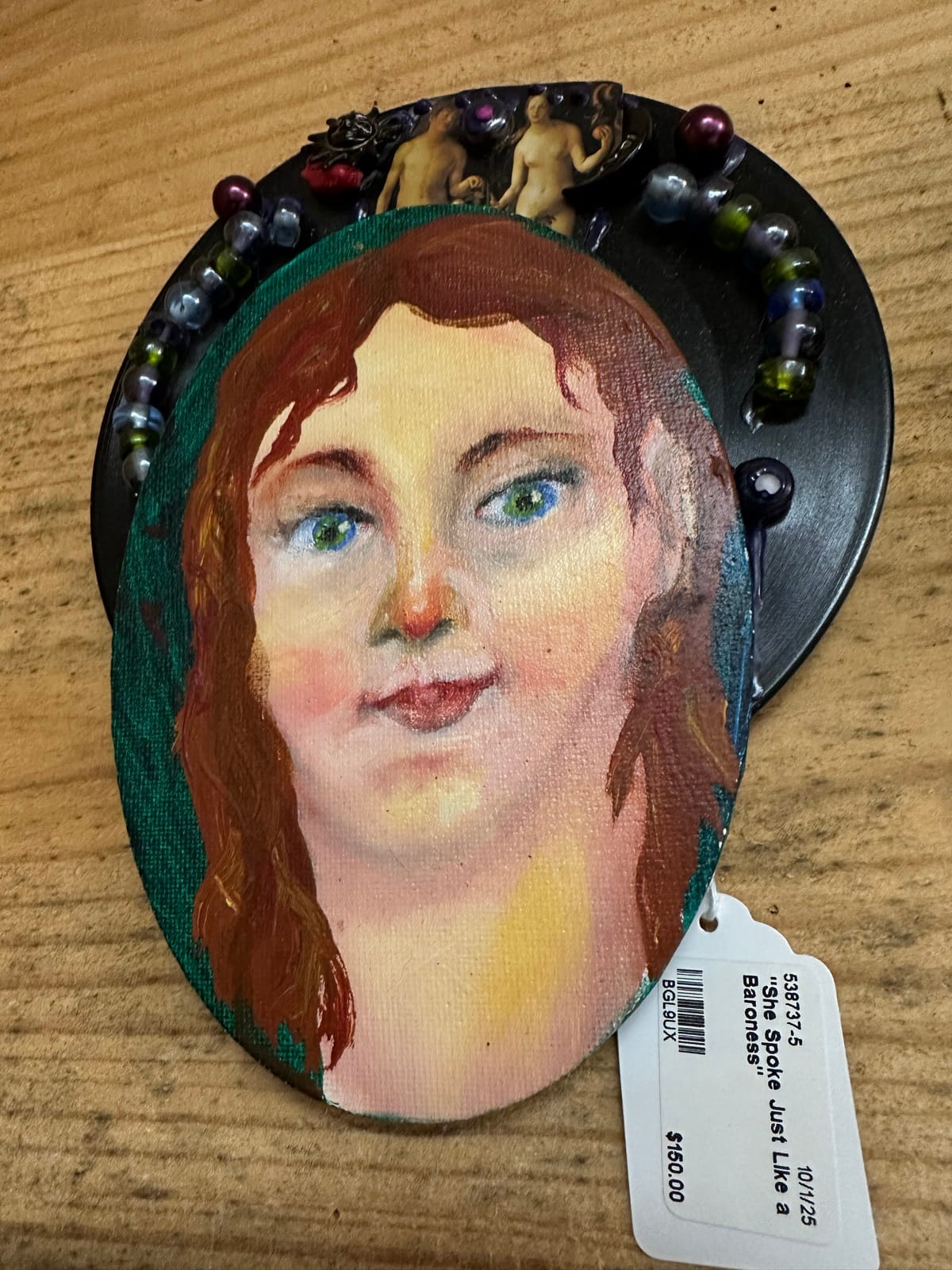 Painted portrait on oval surface with beaded embellishment by Adele Elliott
