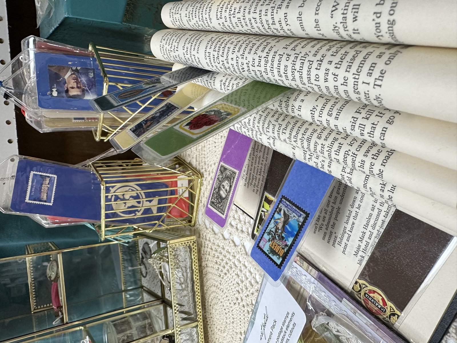 Bookmarks, miniature art prints, and folded book art pieces on display