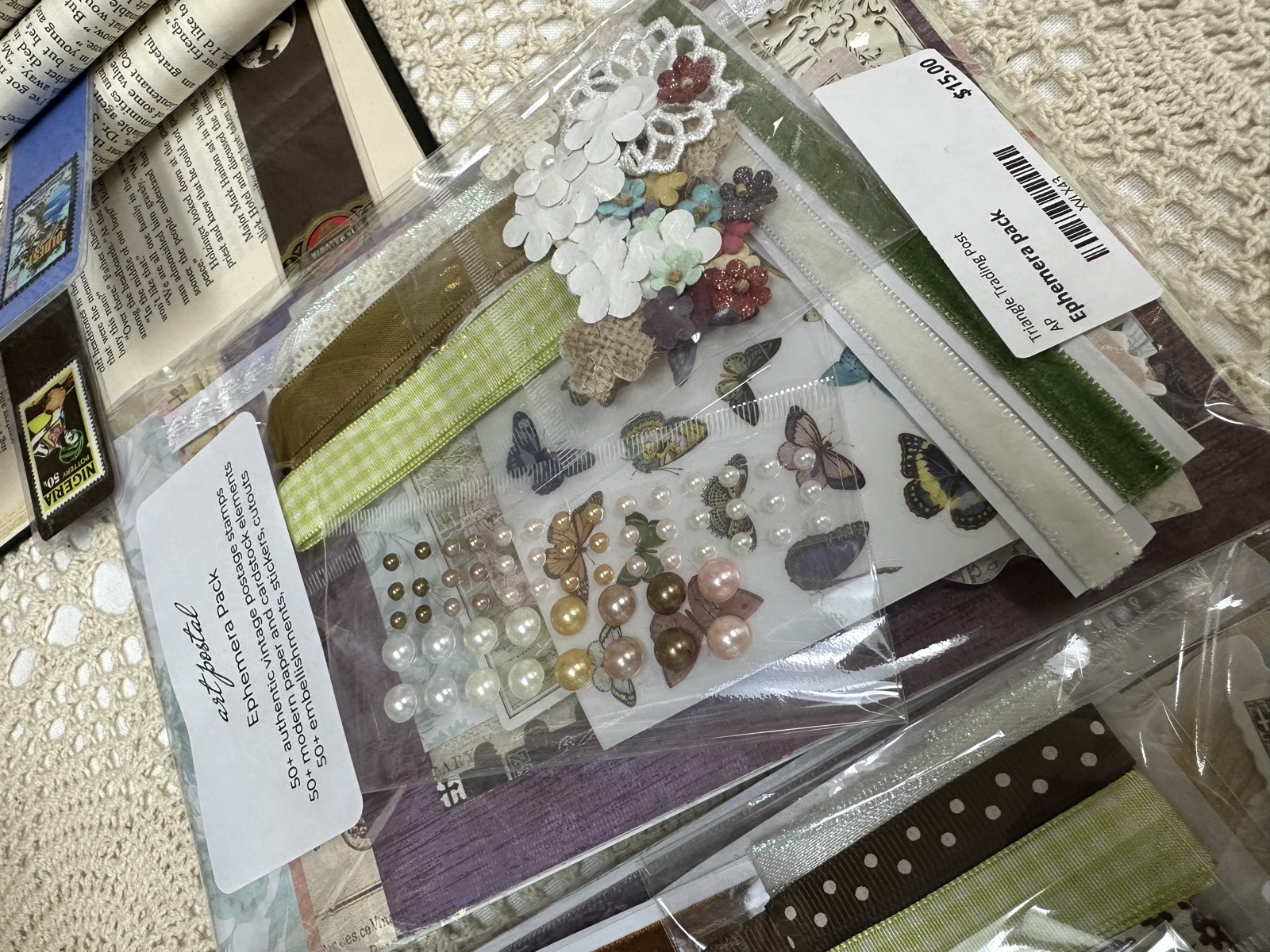 Packaged craft embellishments with butterflies, pearls, and floral pieces