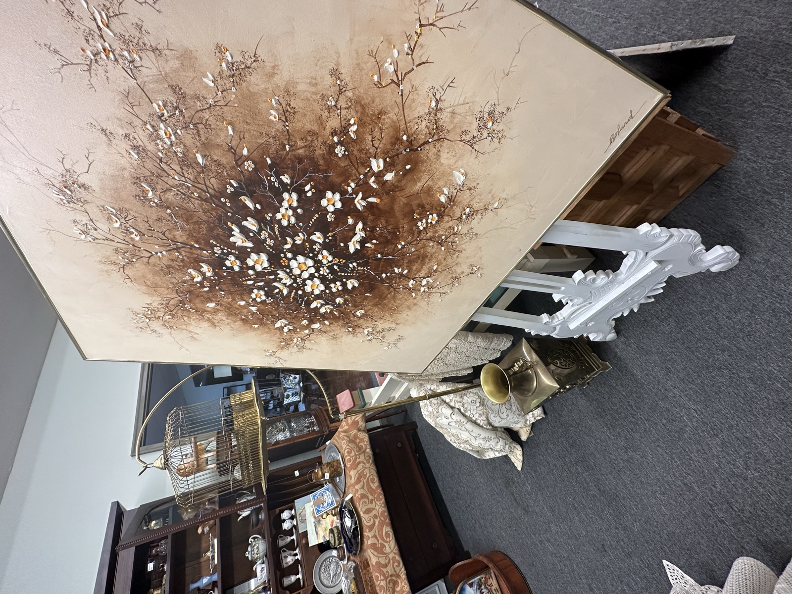 BackRho booth with large floral painting and antique pieces inside Triangle Trading Post