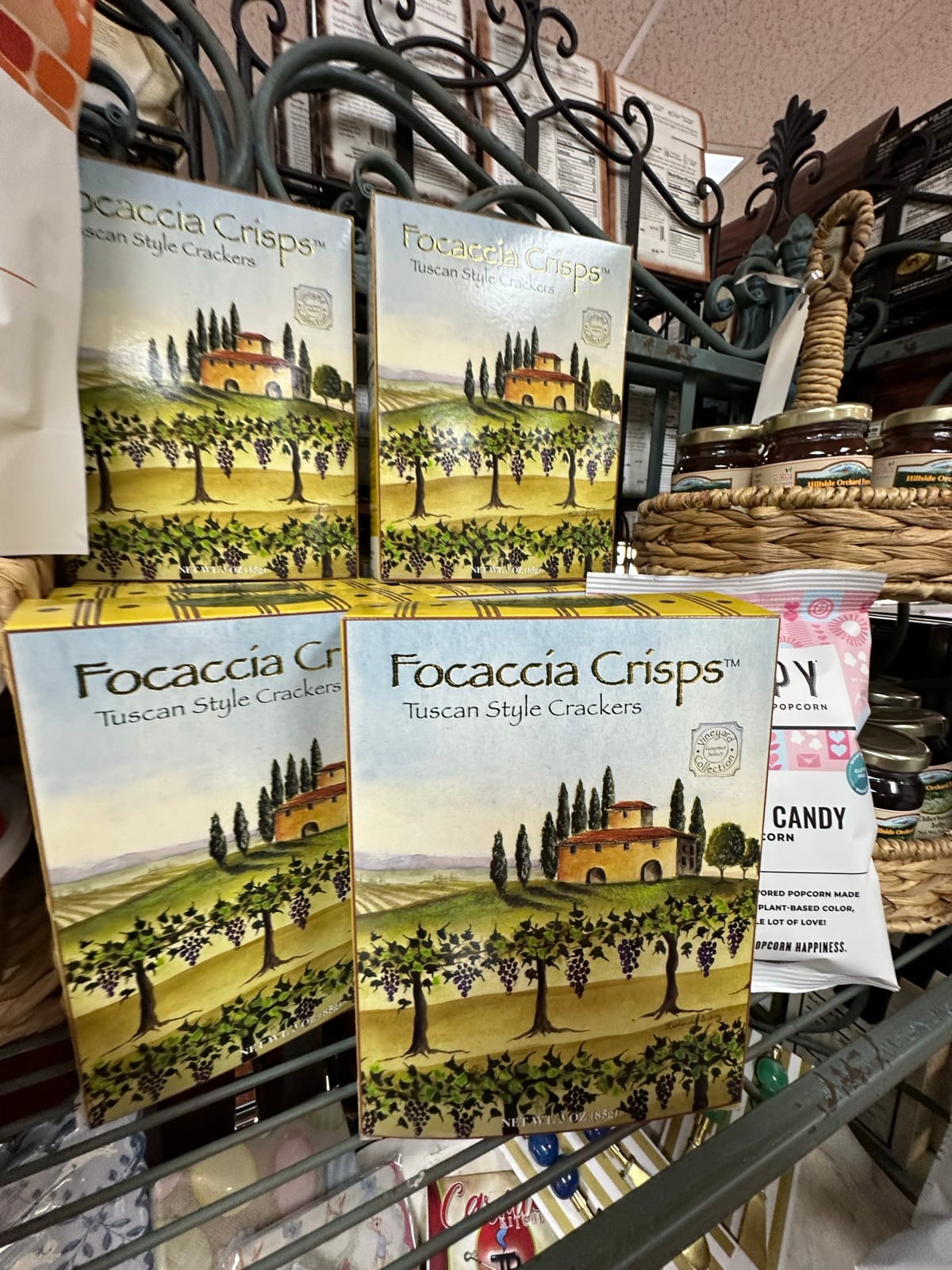 Focaccia Crisps and gourmet snack packages in a wire basket