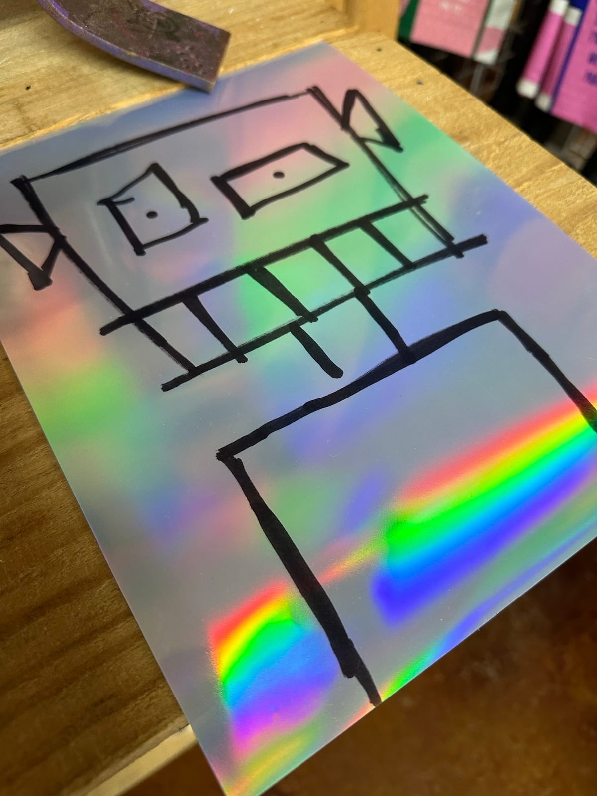 Holographic sticker with line-drawn building artwork