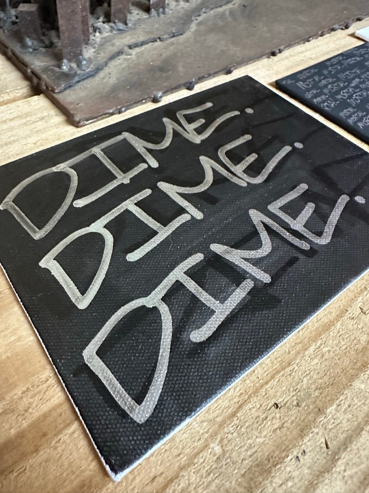 Close-up of graffiti-style lettering on canvas