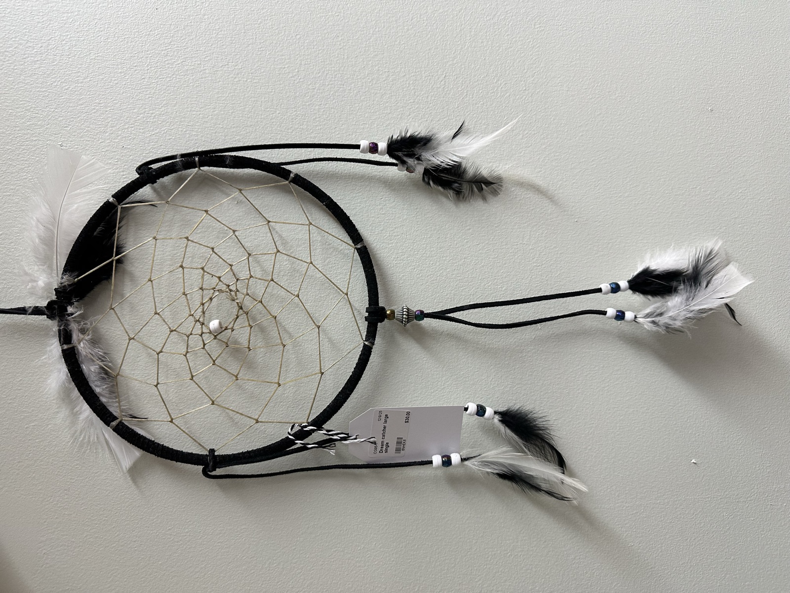 Black dreamcatcher with black and white feathers
