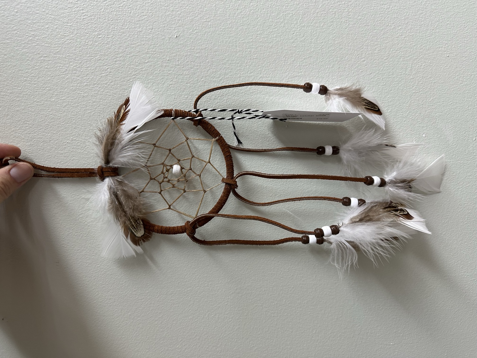Handmade dreamcatcher with brown leather wrapping and natural feathers by Dreams by Christine