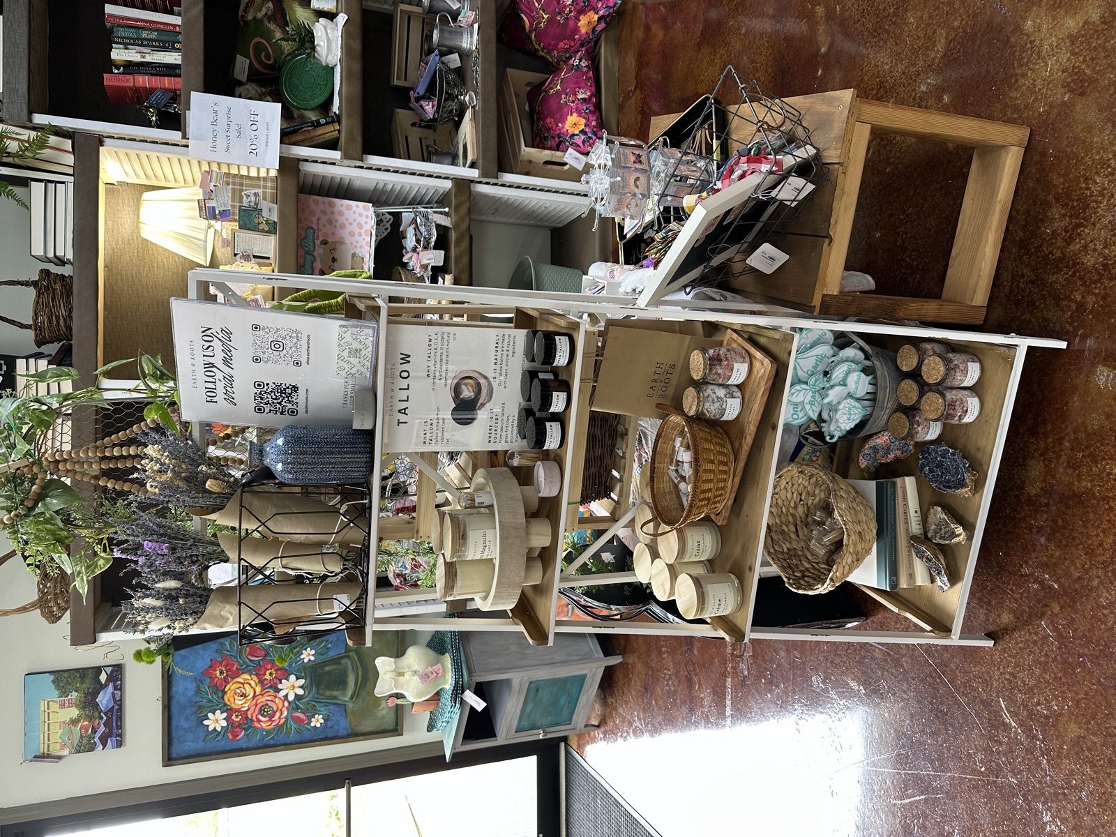 Earth and Roots booth with natural products, baskets, and home goods on shelves