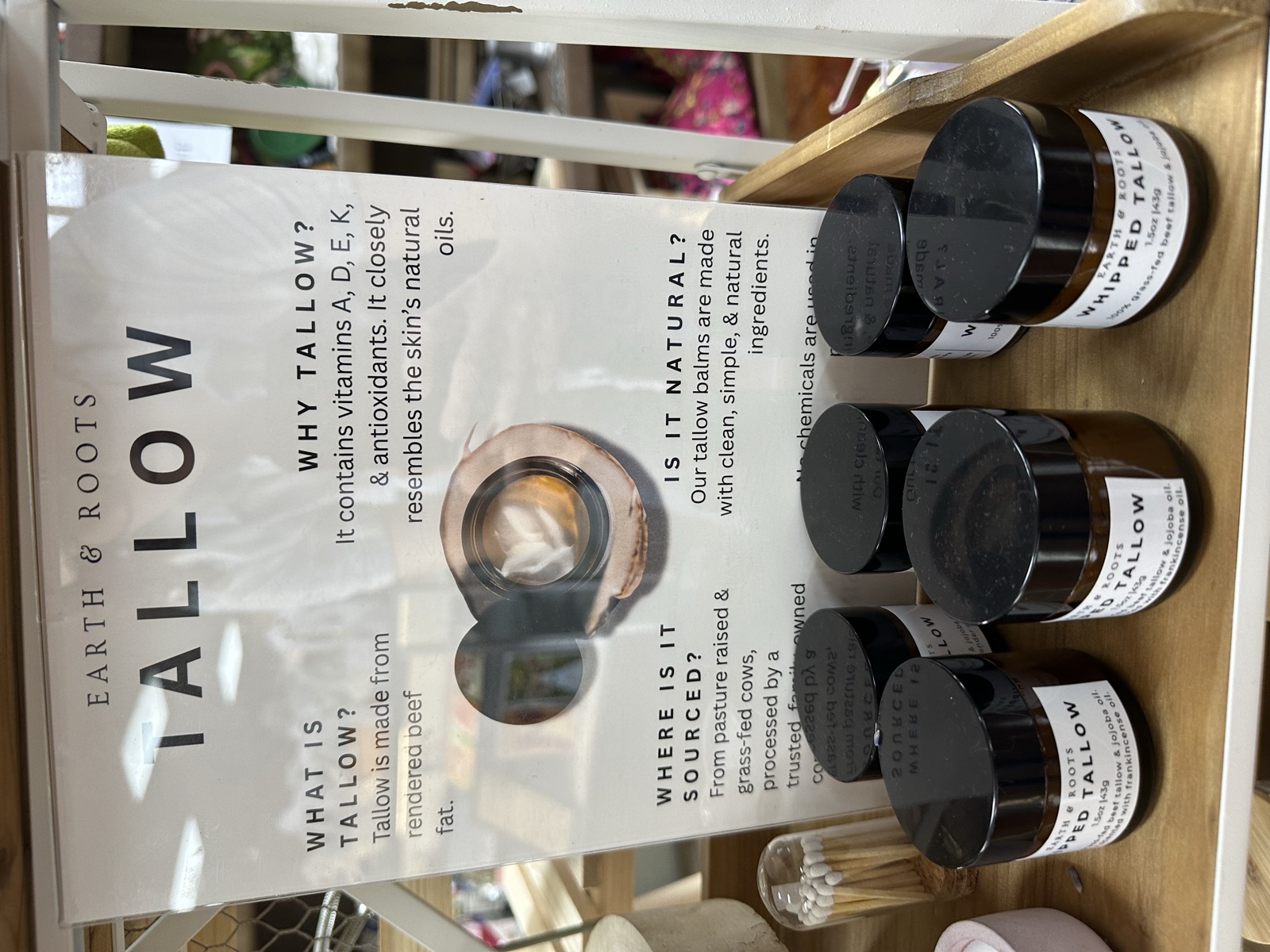 Earth and Roots tallow skincare display with product information at Triangle Trading Post