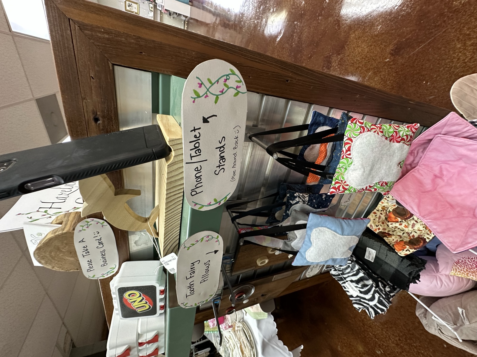 Wooden phone and tablet stands alongside sewn accessories
