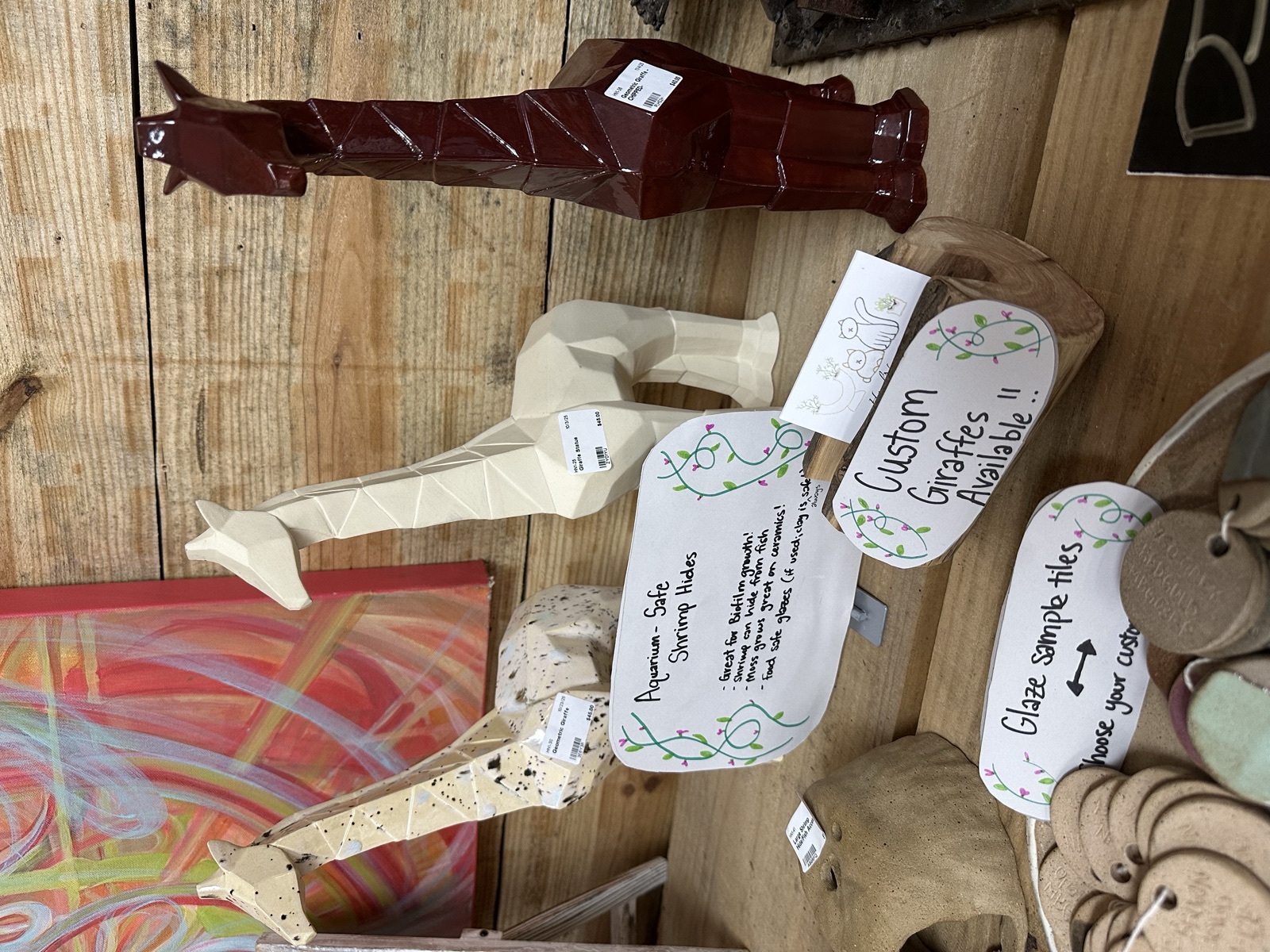 Handmade ceramic guitar-shaped figures in glazed and unglazed finishes