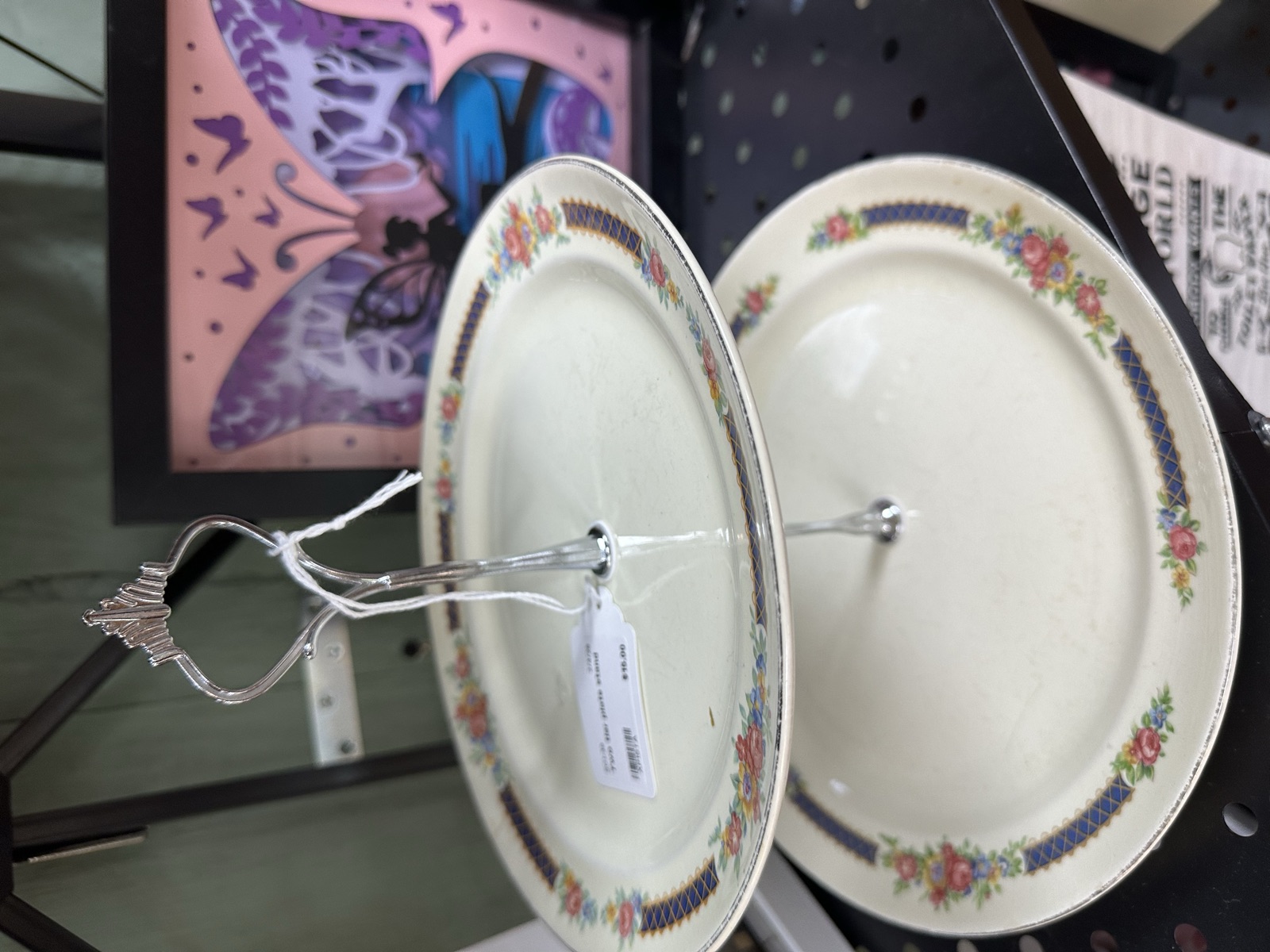Two-tiered serving stand made from vintage floral china plates with metal handle