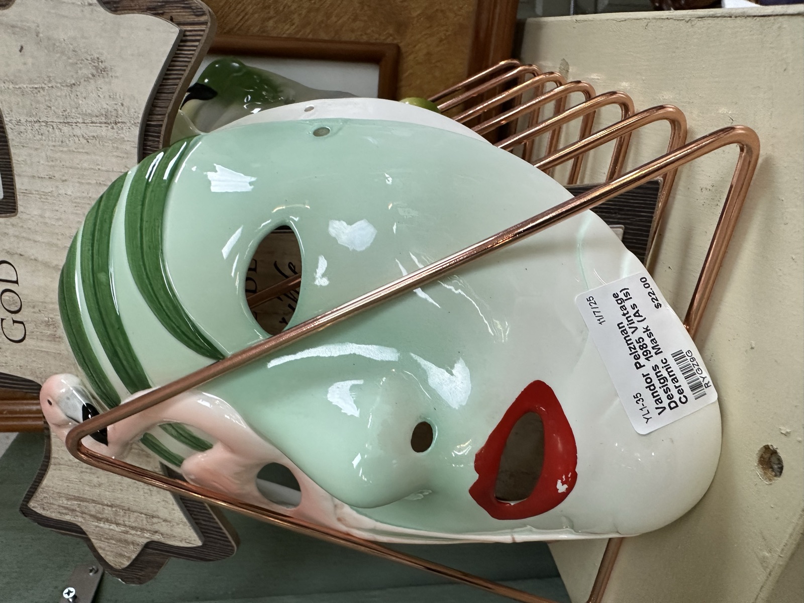 Vintage ceramic face planters in a copper rack
