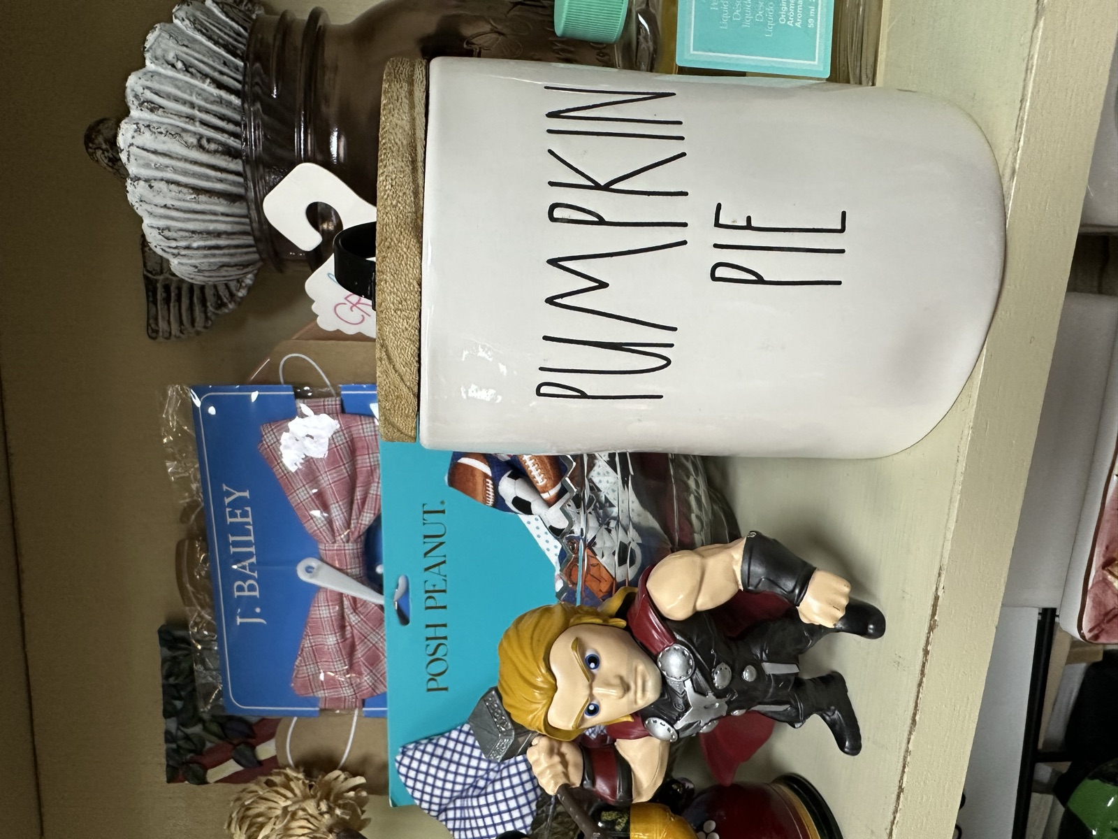 YoLi's Treasures booth with Rae Dunn canister, action figures, and vintage décor inside Triangle Trading Post