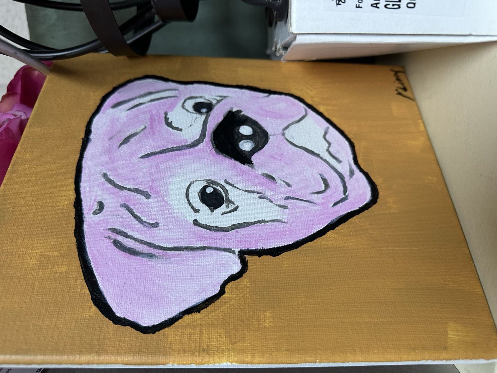 Small painting of a stylized pink character on gold background